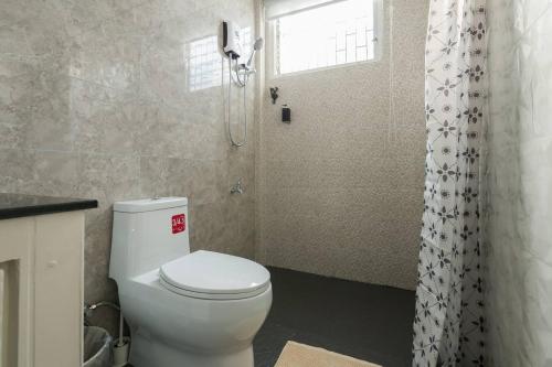 a bathroom with a white toilet and a shower at Inner Old Town 196 Chic Guesthouse in Bangkok