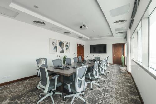 a conference room with a long table and chairs at Gewan White Beach Resort-New Alamein in Marsa Matruh