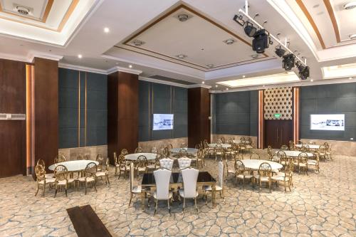 a banquet hall with tables and chairs in a room at Gewan White Beach Resort-New Alamein in Marsa Matruh