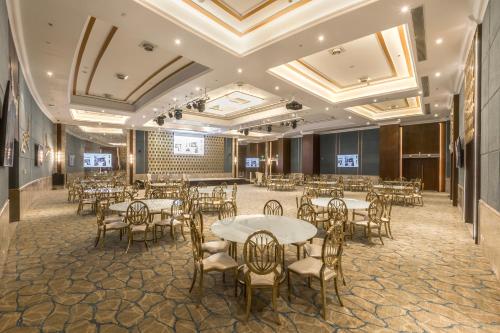 a banquet hall with tables and chairs in a room at Gewan White Beach Resort-New Alamein in Marsa Matruh