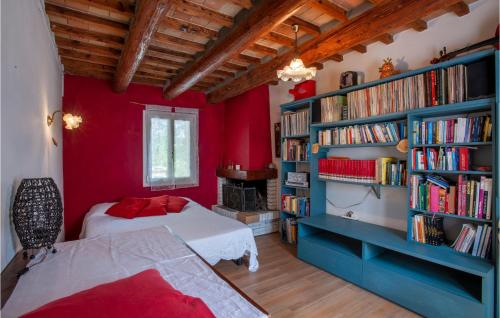 1 dormitorio con 2 camas y una estantería con libros en Awesome Home In Piagge With Wifi, 4 Bedrooms And Outdoor Swimming Pool, en Piagge
