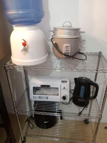 a shelf in a refrigerator with a toaster and a appliance at 1 BR Centrio Tower 926 in Cagayan de Oro