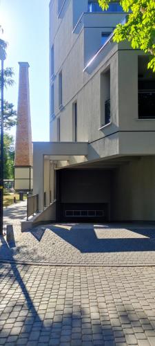 a building with a shadow on the ground in front of it at Apartament Centrum II in Bydgoszcz