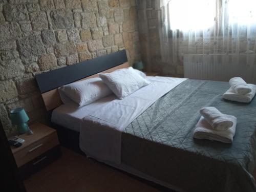 a bedroom with a bed with towels on it at Rodiola House in Afitos