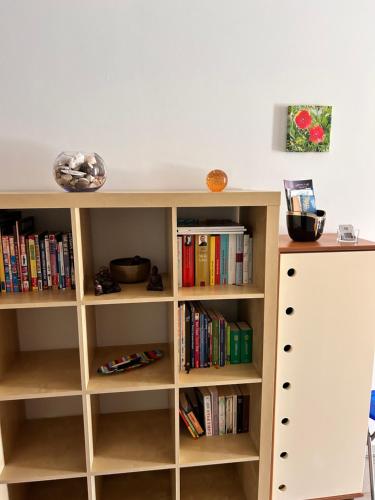 a book shelf filled with books in a room at Vista Dourada in Porto Santo