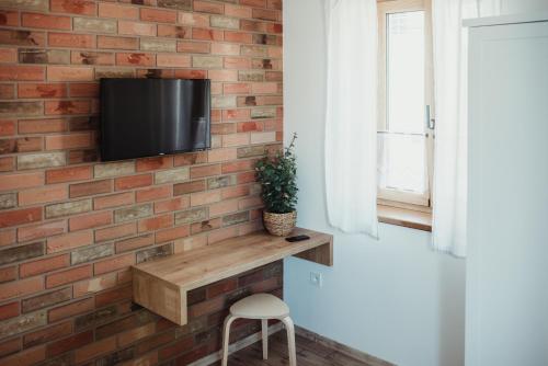 a brick accent wall with a tv on a brick wall at Apartmány Skoronice in Skoronice