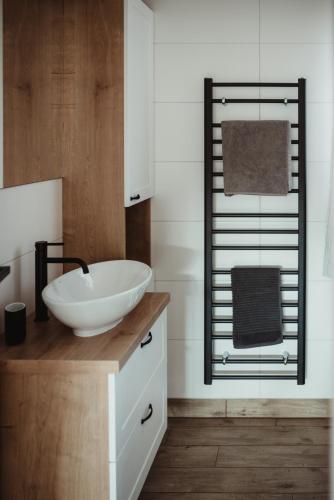a bathroom with a white sink and a mirror at Apartmány Skoronice in Skoronice
