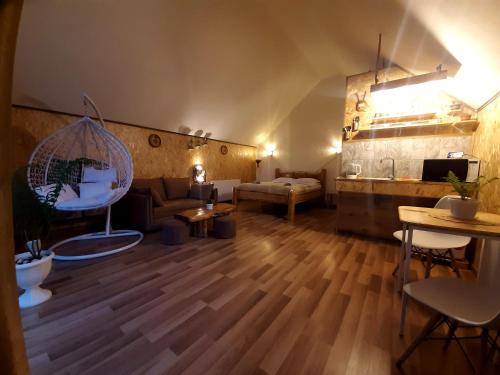 a living room with a couch and a table at Kazbegi cottages qabarjina in Kazbegi