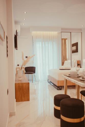 a living room with a bed and a table at Aelia - Luxury Central Suite in Alexandroupoli