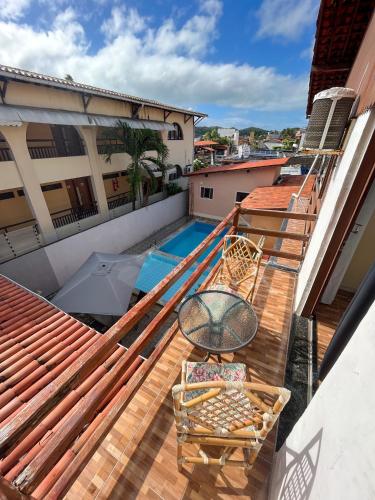 a balcony with a view of a swimming pool at Pousada Recanto de Ponta Negra in Natal