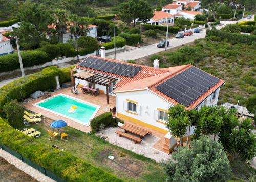 an aerial view of a house with solar panels on its roof at Casa Ensolarada B&B and Pottery in Aljezur