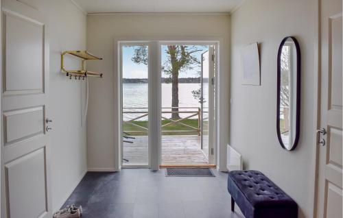 a hallway with a door with a view of the water at Cozy Home In Nssj With House Sea View in Nässjö