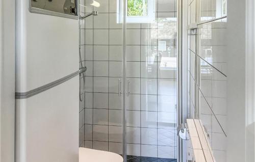 a bathroom with a glass shower with a toilet at Awesome Apartment In Slen With Wifi in Stöten