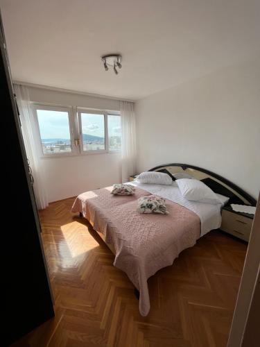 a bedroom with a bed with two pillows on it at Sunny Corner in Split