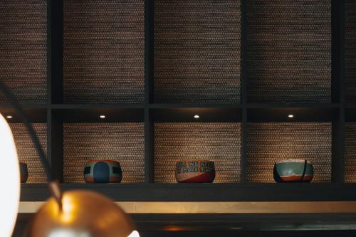 a shelf with three vases sitting on it at W Melbourne in Melbourne