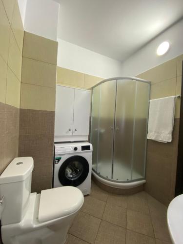 a bathroom with a toilet and a washing machine at Xh&S apartment in Durrës