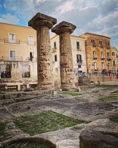 two stone columns in front of a building at Suite Cavour Luxury Home Taranto in Taranto