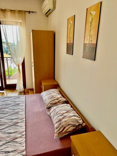 a bedroom with a bed with a pillow on it at Apartment City Center in Ulcinj