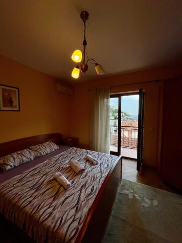 a bedroom with a bed with towels on it at Apartment City Center in Ulcinj