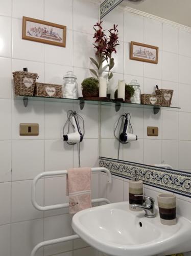 baño con lavabo y pared de azulejos blancos en Dulce hogar, en Santiago