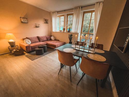 a living room with a table and a couch at Deine Auszeit in Eggesin