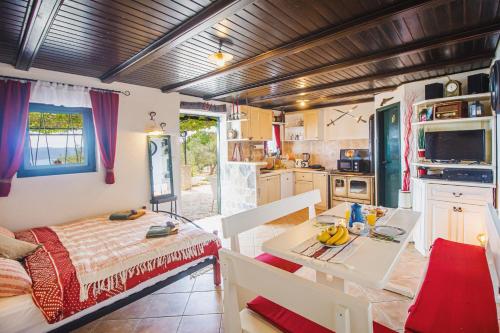 a kitchen with a table and a dining room at Holiday home Oaza in Baška Voda