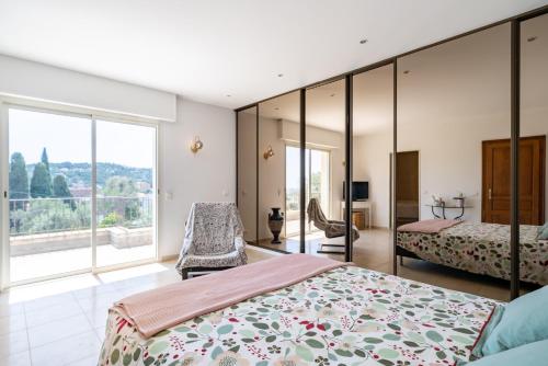 une chambre avec deux lits et une grande fenêtre dans l'établissement Villa Super Cannes, à Vallauris
