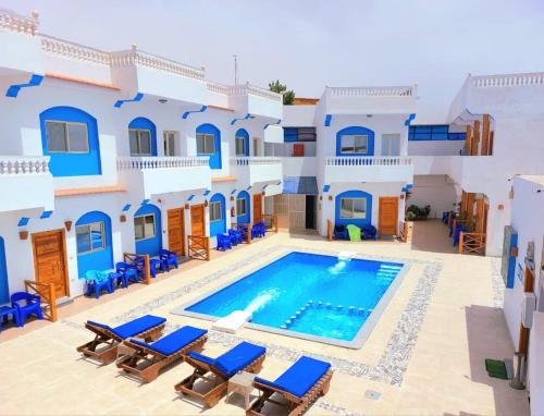a villa with a swimming pool and blue at Dahab Beach Lodge in Dahab