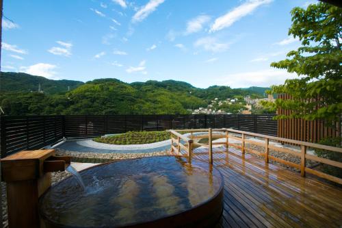 un jacuzzi en la terraza de una casa en Fukiya Ryokan, en Yugawara