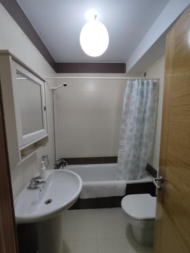 a bathroom with a sink and a tub and a toilet at Apartamento en Finisterre Fisterra in Finisterre