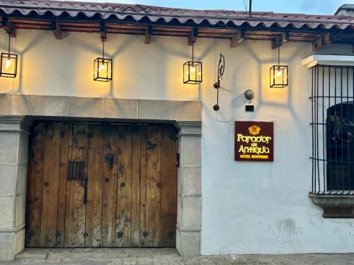 a building with a wooden door and a sign on it at Parador de Antigua in Antigua Guatemala