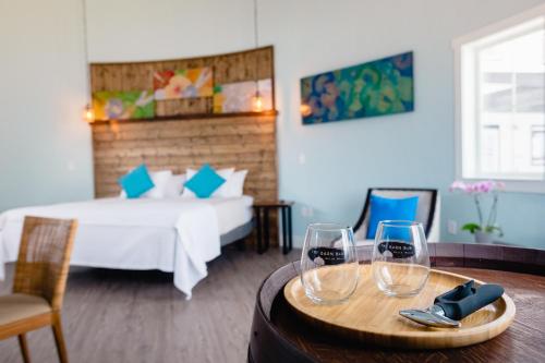 a room with a bed and two wine glasses on a table at The Barn B&B Walla Walla in Walla Walla