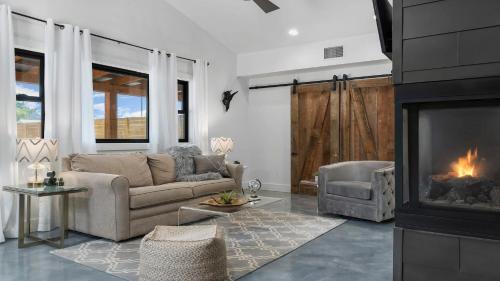 a living room with a couch and a fireplace at An Enchanted Hideaway outdoor fireplace hot tub in Fredericksburg