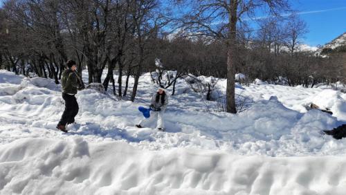 two people walking through a pile of snow at La Ruta de Los Volcanes - Las Trancas Chillán in Las Trancas