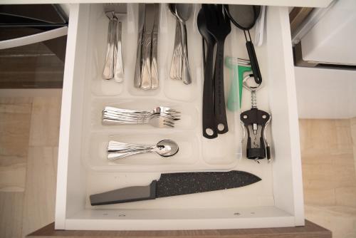 a drawer filled with utensils in a kitchen at Naiads Nest - The Blue Wave in Varkiza