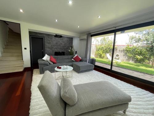 a living room with a couch and a table at Villa Madeira island in Caniço