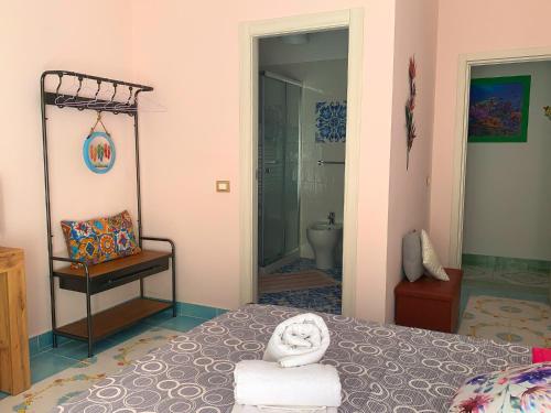 a bedroom with a bed with towels on it at Mille tramonti Agropoli sunset suite in Agropoli