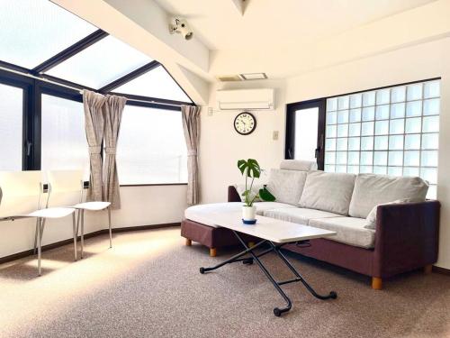 a living room with a couch and a table at 池袋三駅の家 大山駅から徒歩4分 in Tokyo