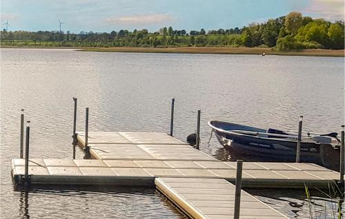 a boat is docked at a dock on a lake at Awesome Home In Trans With Lake View in Tranås