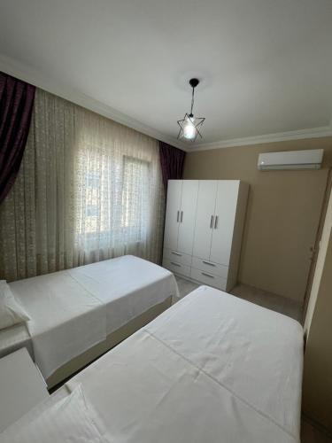 Ένα ή περισσότερα κρεβάτια σε δωμάτιο στο Anatolia SUITE APART
