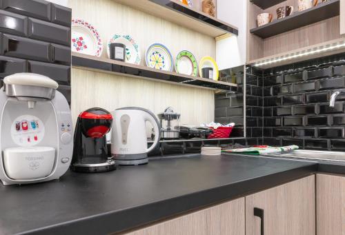 a kitchen counter with a coffee maker on it at (Stoa escape) traditional home in Archangelos