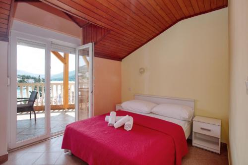 a bedroom with a bed with a towel on it at Apartments by the sea Grebastica, Sibenik - 20736 in Grebaštica