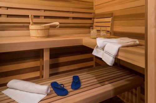 a sauna with two towels and blue shoes in it at Lotus Provincetown in Provincetown