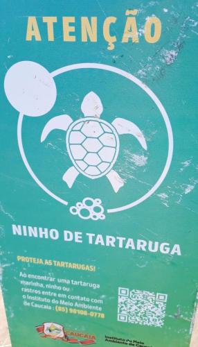 a sign with a picture of a turtle and a symbol at VG SUN CUMBUCO-Lake Flat C1 201 1 a 4 pessoas in Caucaia