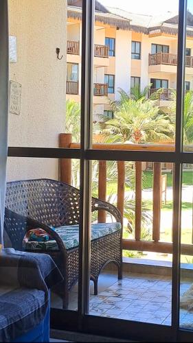 a view from a window of a balcony with a bench at VG SUN CUMBUCO-Lake Flat C1 201 1 a 4 pessoas in Caucaia