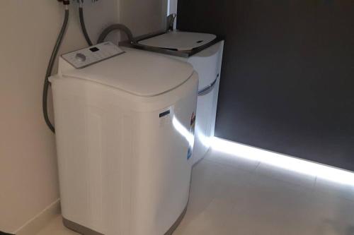 a white trash can with a light on top of it at Homely and newly built place with a lot to do. in Beaconsfield