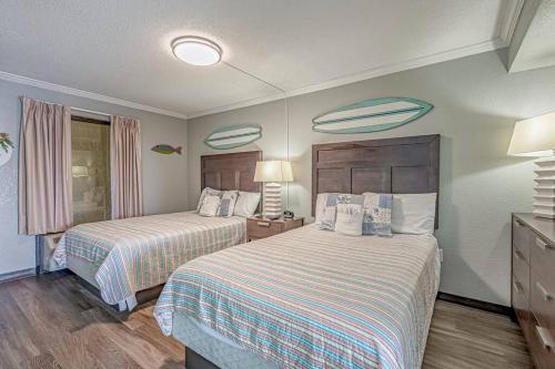 a hotel room with two beds with striped sheets at Caravelle Resort in Myrtle Beach