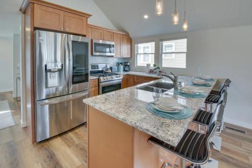 a kitchen with a granite counter top and stainless steel appliances at Luxurious Historic Renovated Bungalow DT Rapid City with Private Patio in Rapid City
