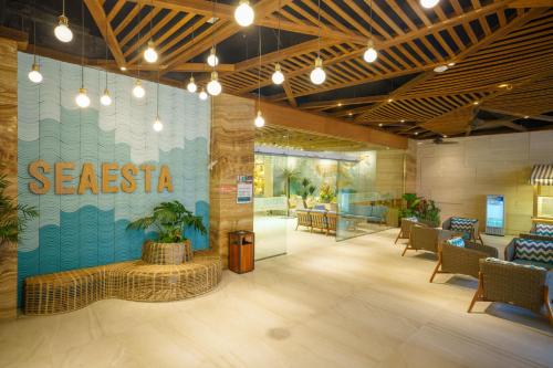 a restaurant lobby with a siesta sign on the wall at Seaesta Nha Trang Hotel in Nha Trang