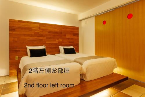 a hotel room with two beds and floor left room at 海まで徒歩1分 沖縄でも珍しい絶景ホテル 贅沢プライベートビーチ付き ビーチルーム in Onna